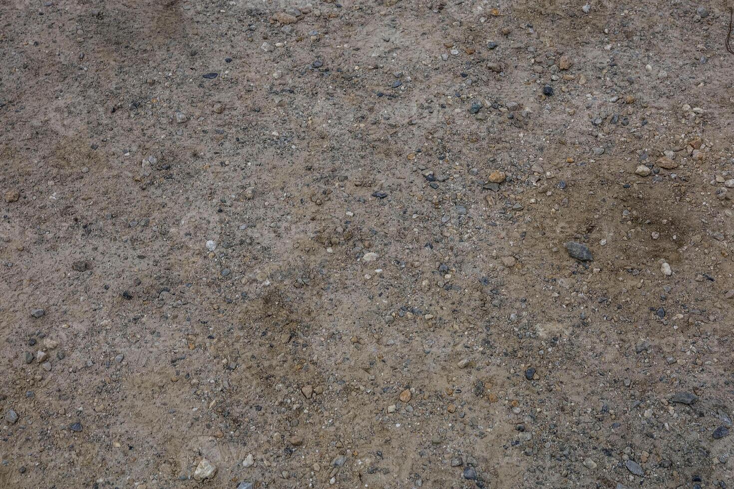 Background and texture of the road surface is made of asphalt and small stones. photo