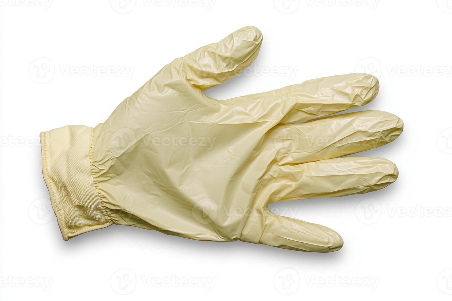 A single pale yellow nitrile glove on a white background photo