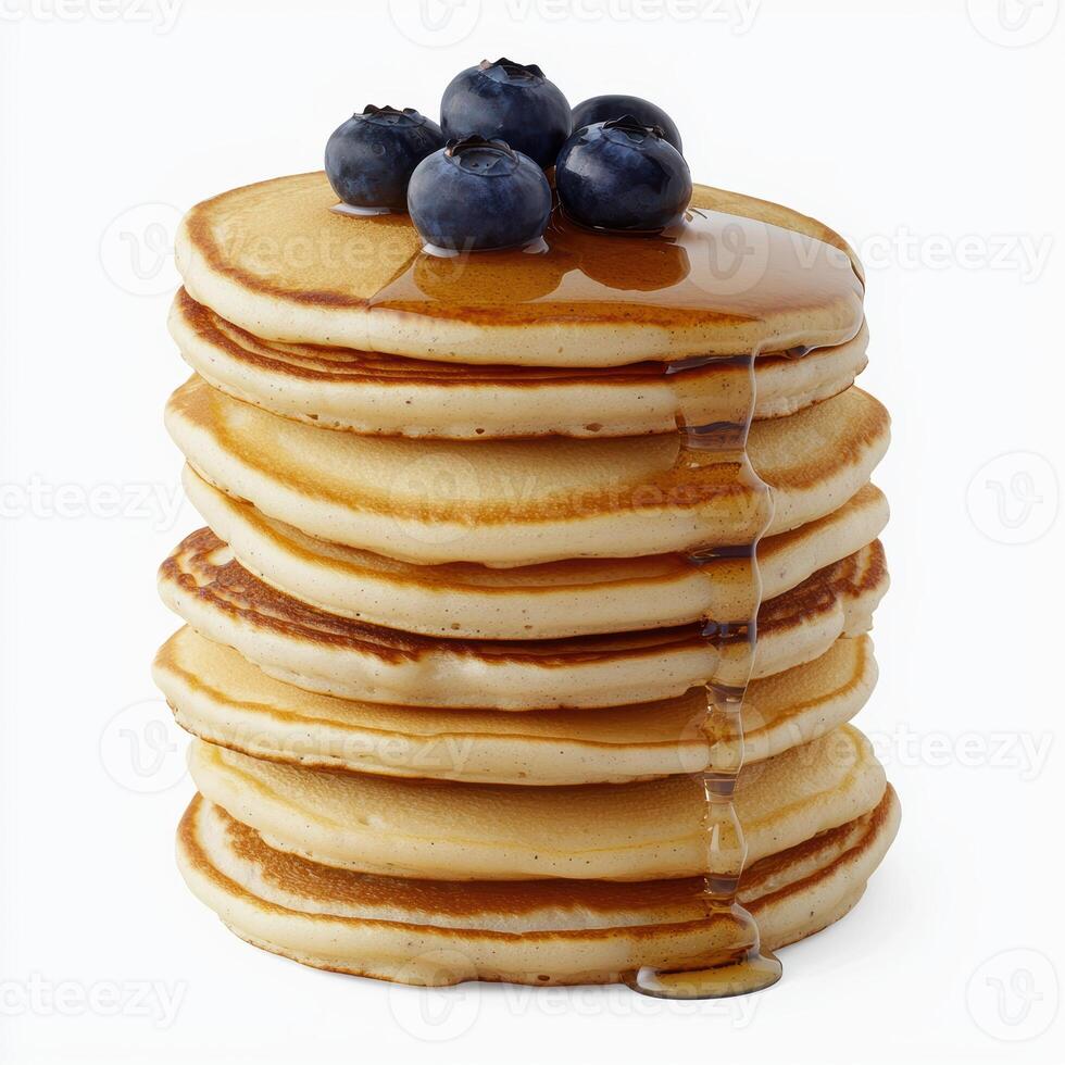 A tall stack of pancakes with blueberries and syrup on top photo