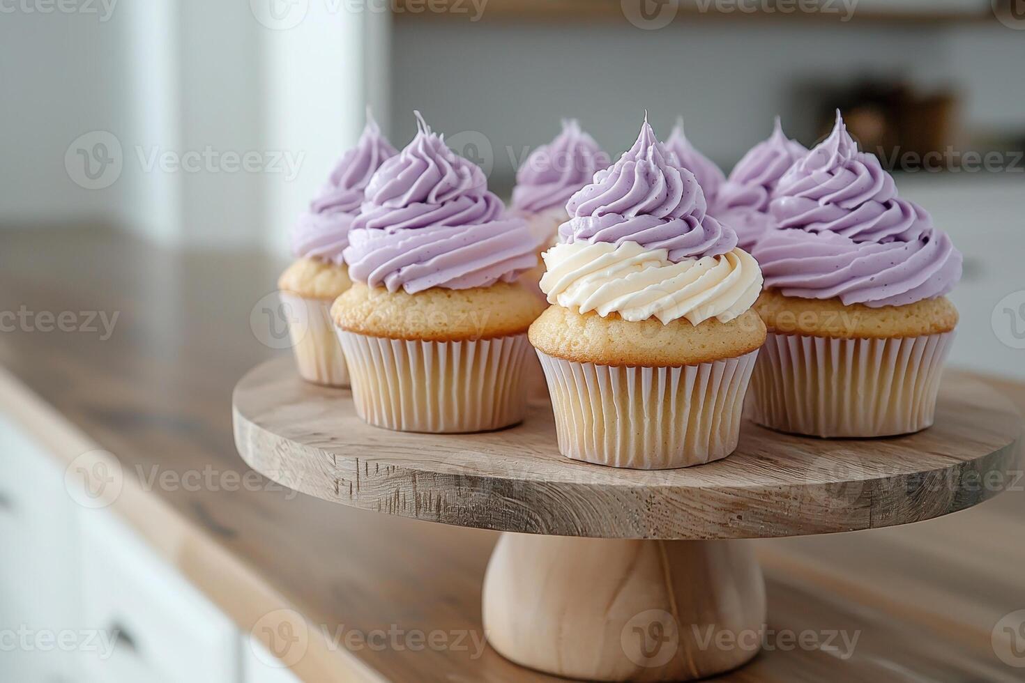 Delicious vanilla cupcakes with lavender frosting on a wooden cake stand photo