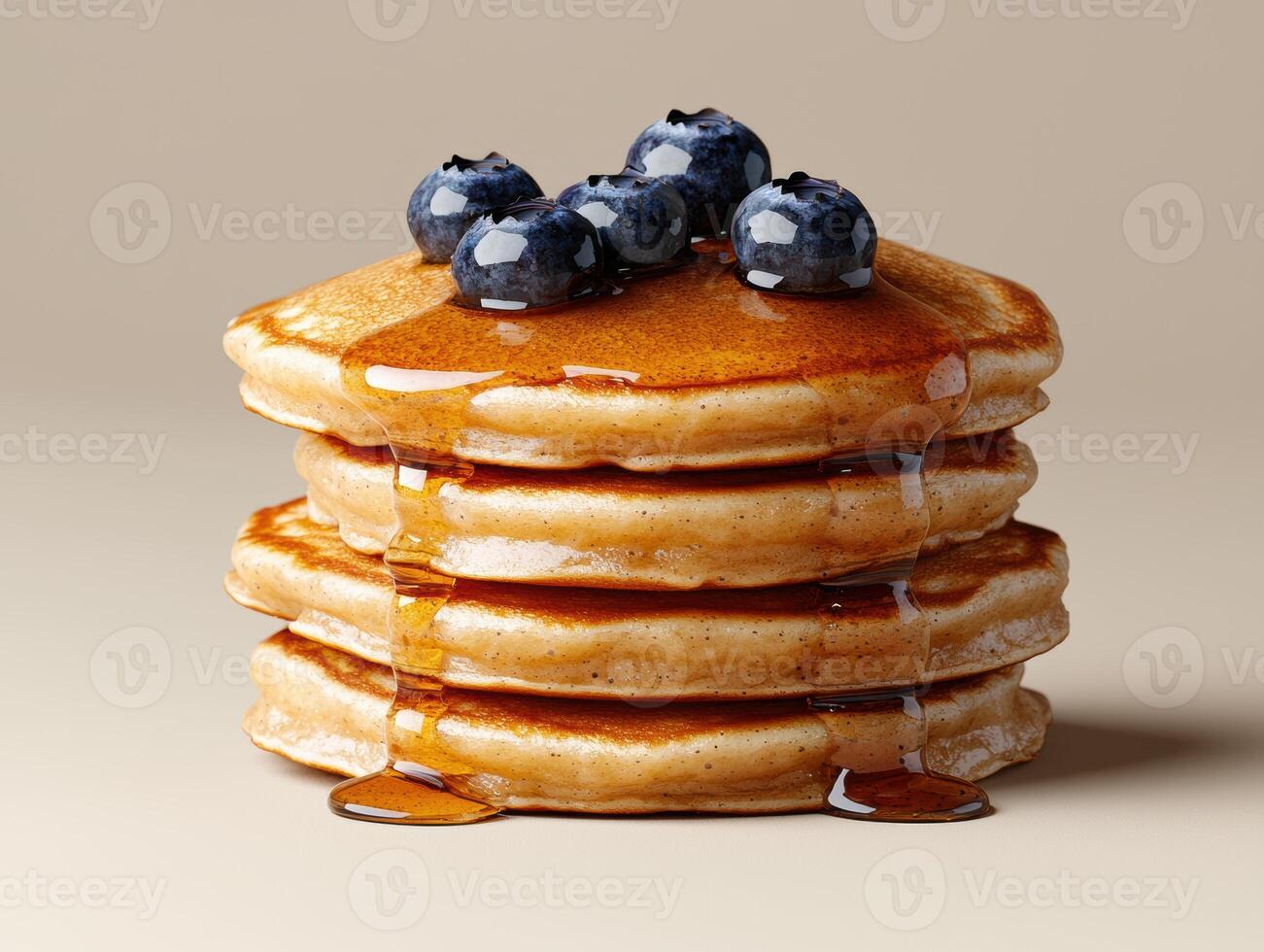 A tall stack of pancakes with blueberries and syrup photo