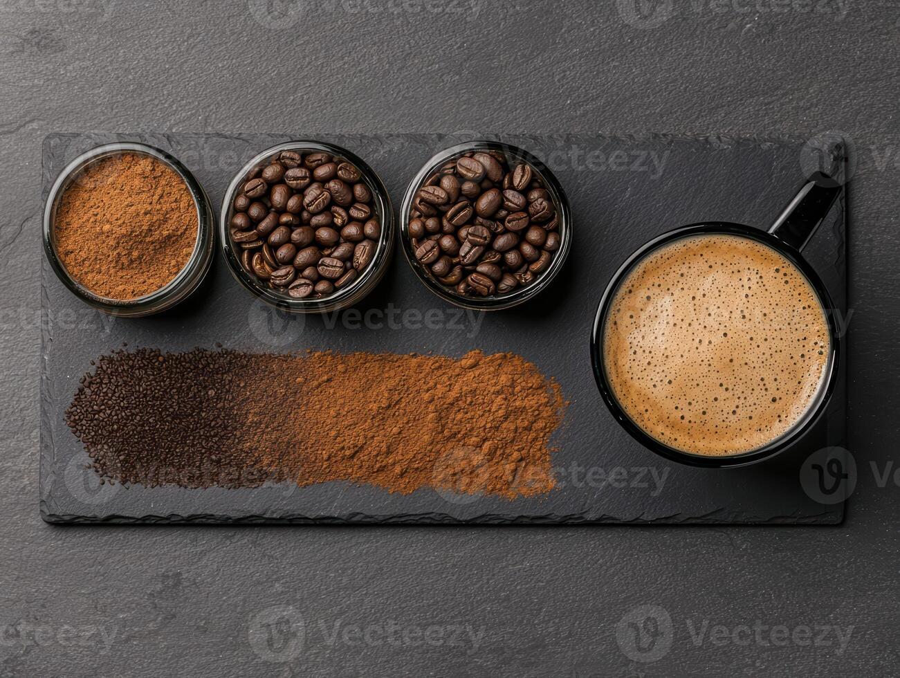 Variety of coffee beans and grounds with a cup of coffee on a dark background photo