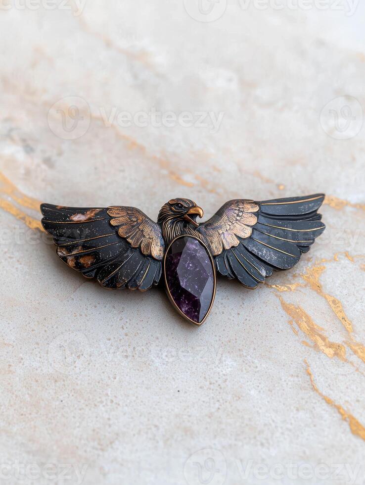 Intricate bronze eagle brooch with purple gemstone photo