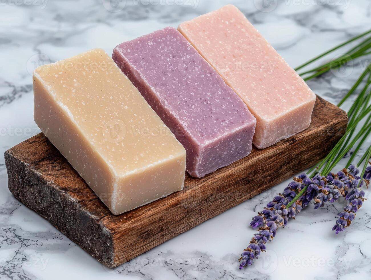 Three bars of handmade soap on a wooden stand photo