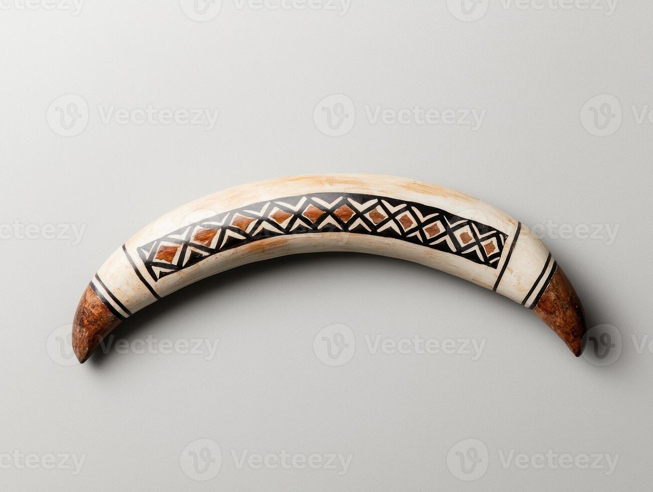 Hand carved bone artifact with geometric patterns photo