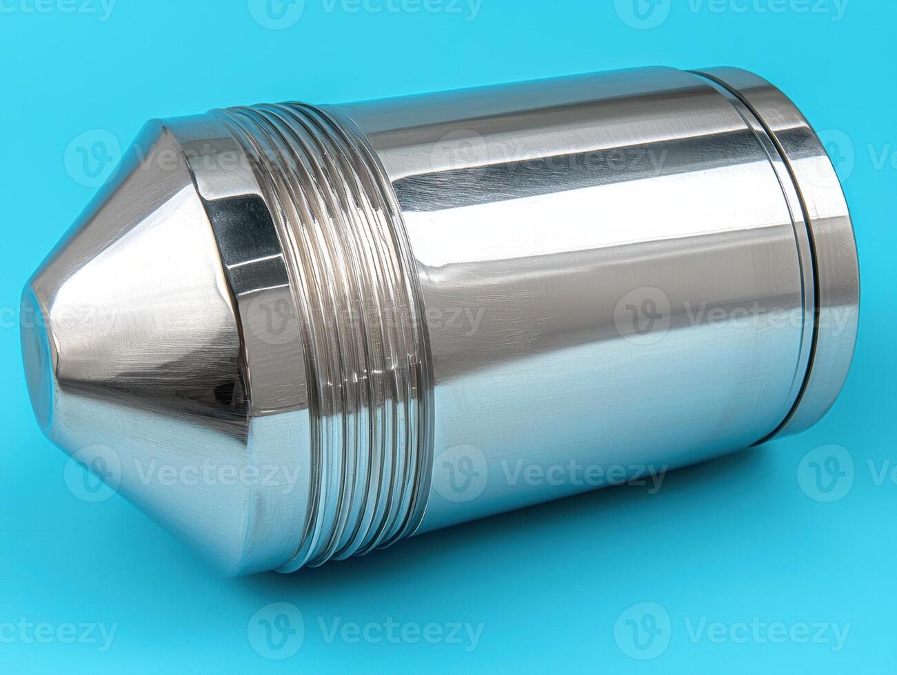 Close up of a polished stainless steel industrial component with a conical end and ribbed section photo