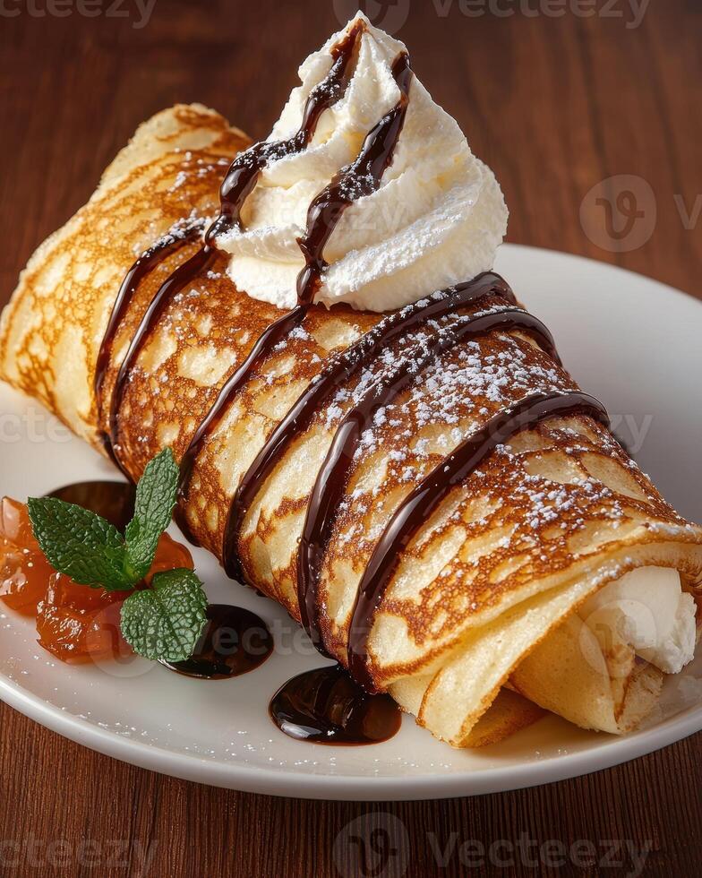 Delicious crepe with whipped cream and chocolate sauce photo
