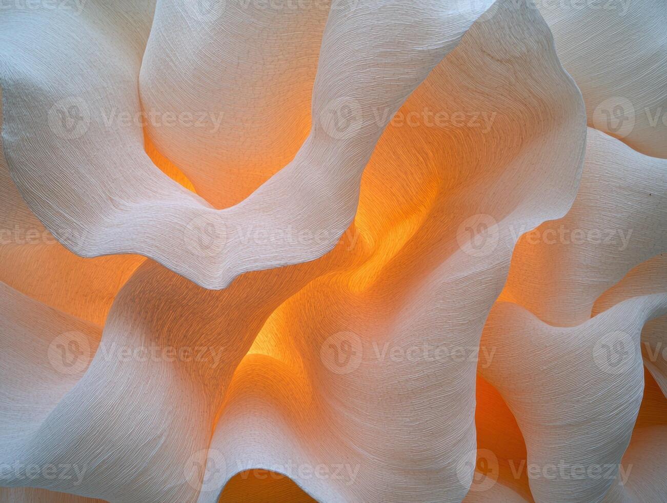 Abstract orange and white textured background, illuminated paper waves, close up photo