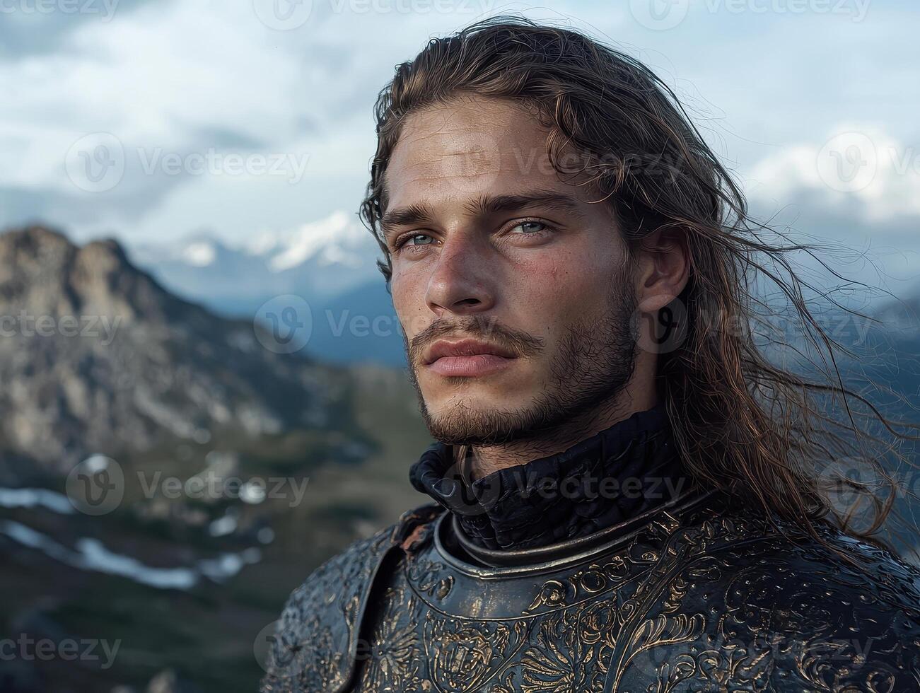 Portrait of a handsome knight in medieval armor against a mountain backdrop photo