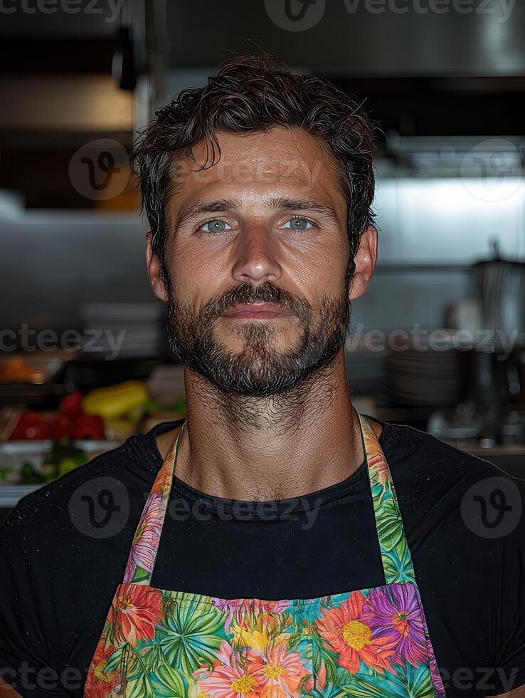 Portrait of a handsome chef in a floral apron photo