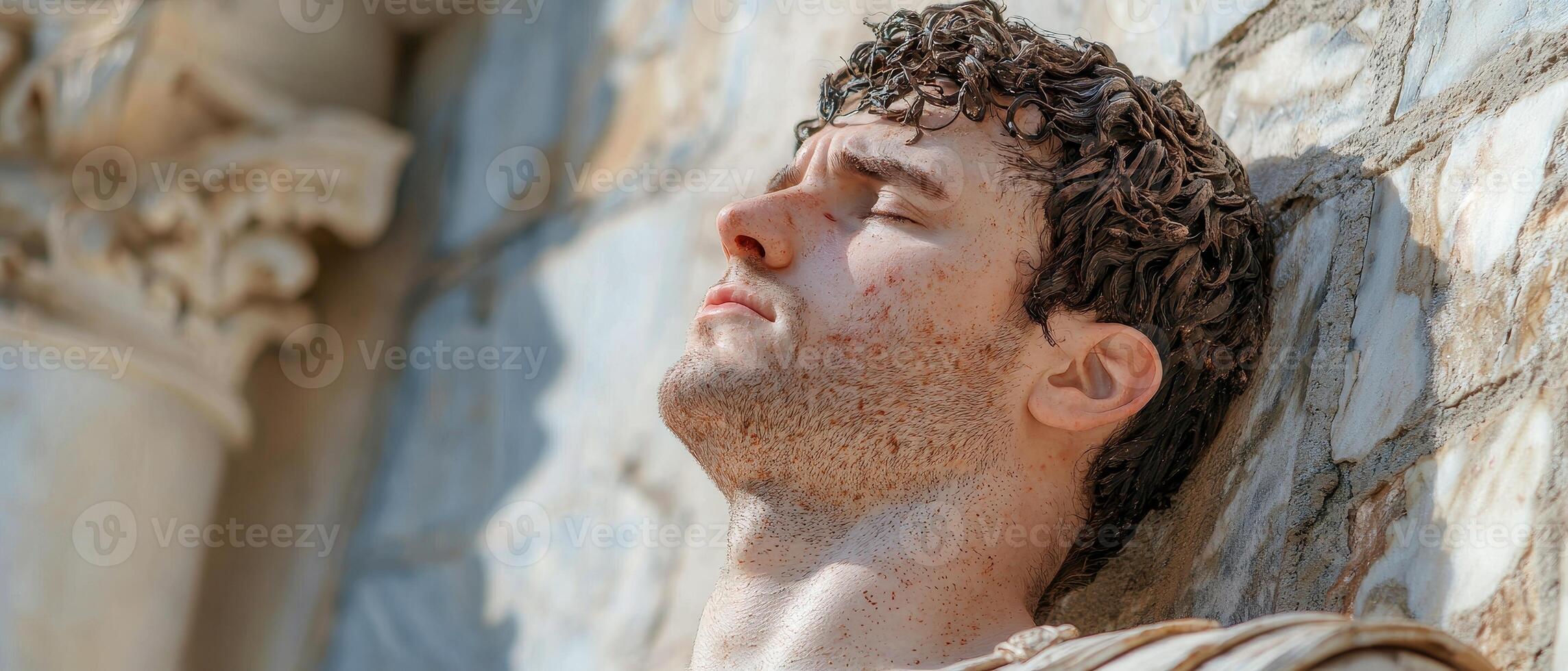 Close up of a mans face, eyes closed, looking peaceful and serene photo