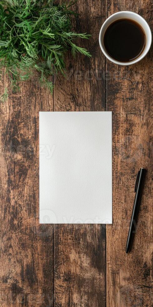 Blank white paper on rustic wooden table with coffee and herbs photo