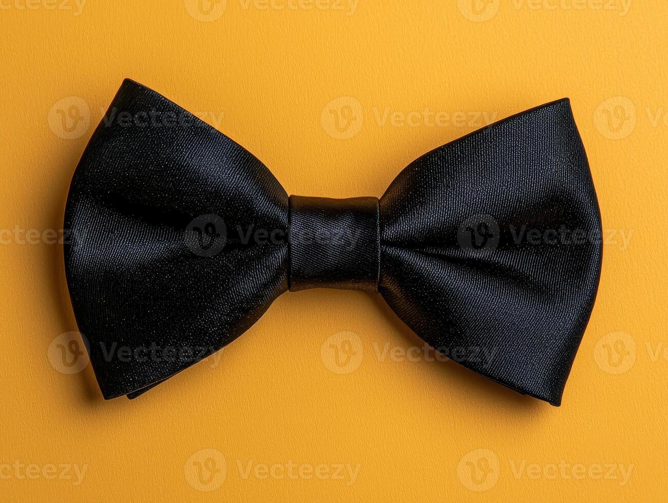A black bow tie on yellow background photo