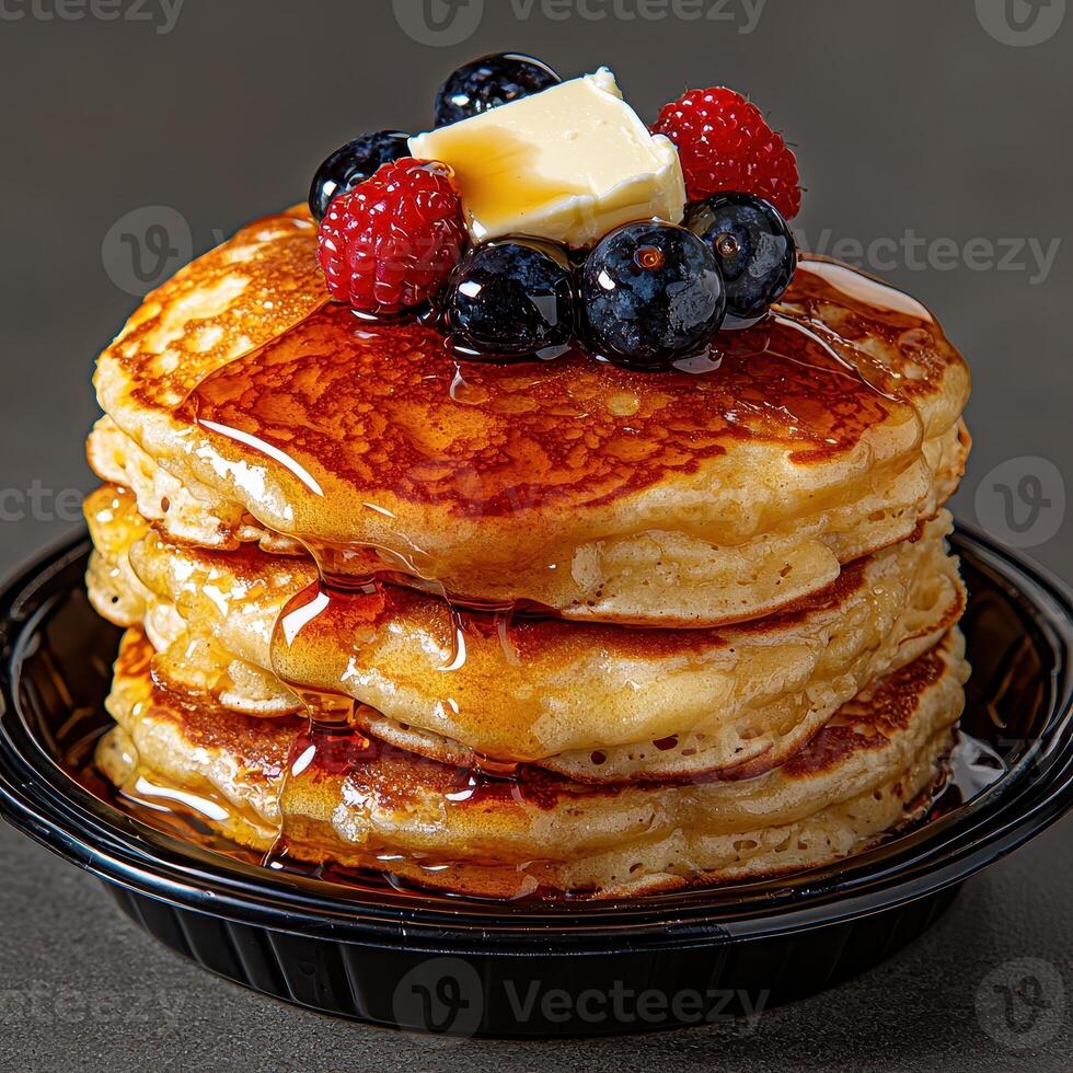 a stack of pancakes with butter and berries photo