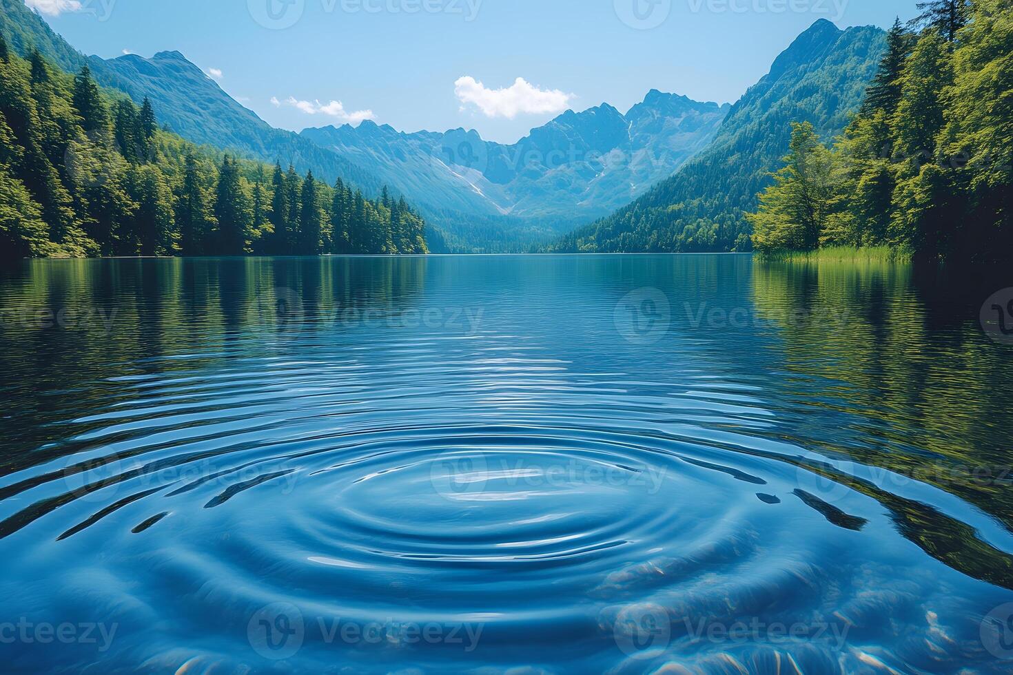 Serene Mountain Lake with Rippling Waters and Majestic Forest Scenery photo