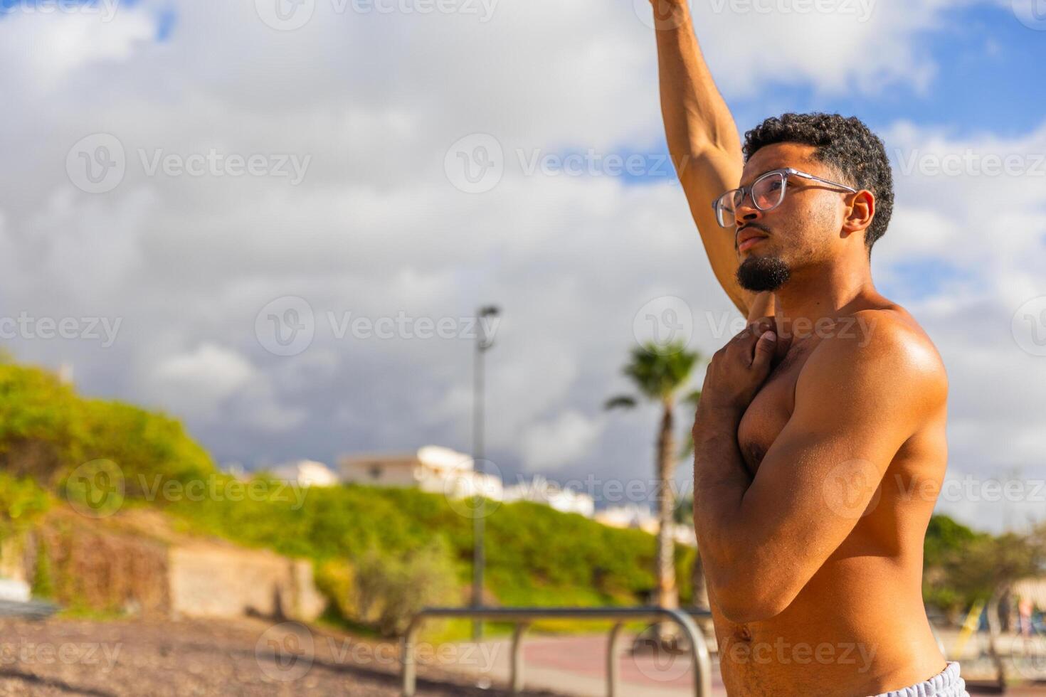 A man is doing stretching exercises while working out outdoors photo
