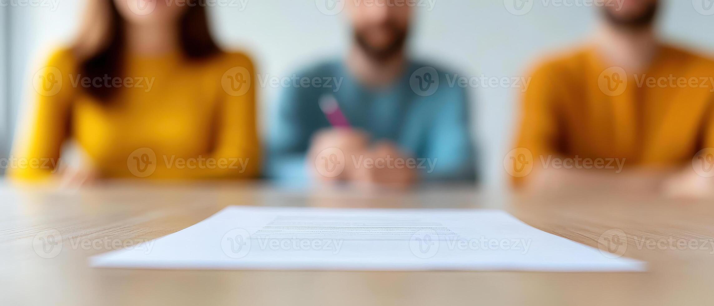 Group discussing investment plans at table, focused on documents photo