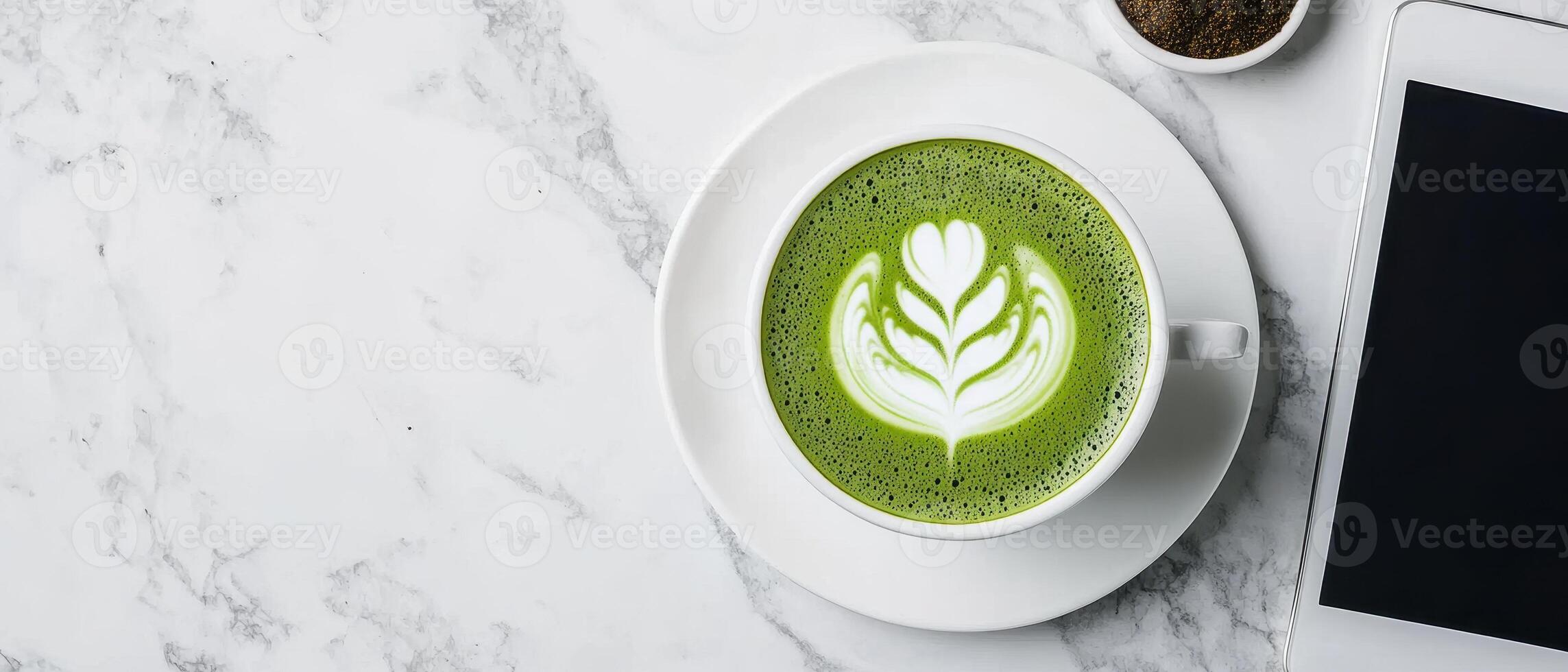 beautifully crafted matcha latte sits on marble table beside tablet, creating serene atmosphere photo