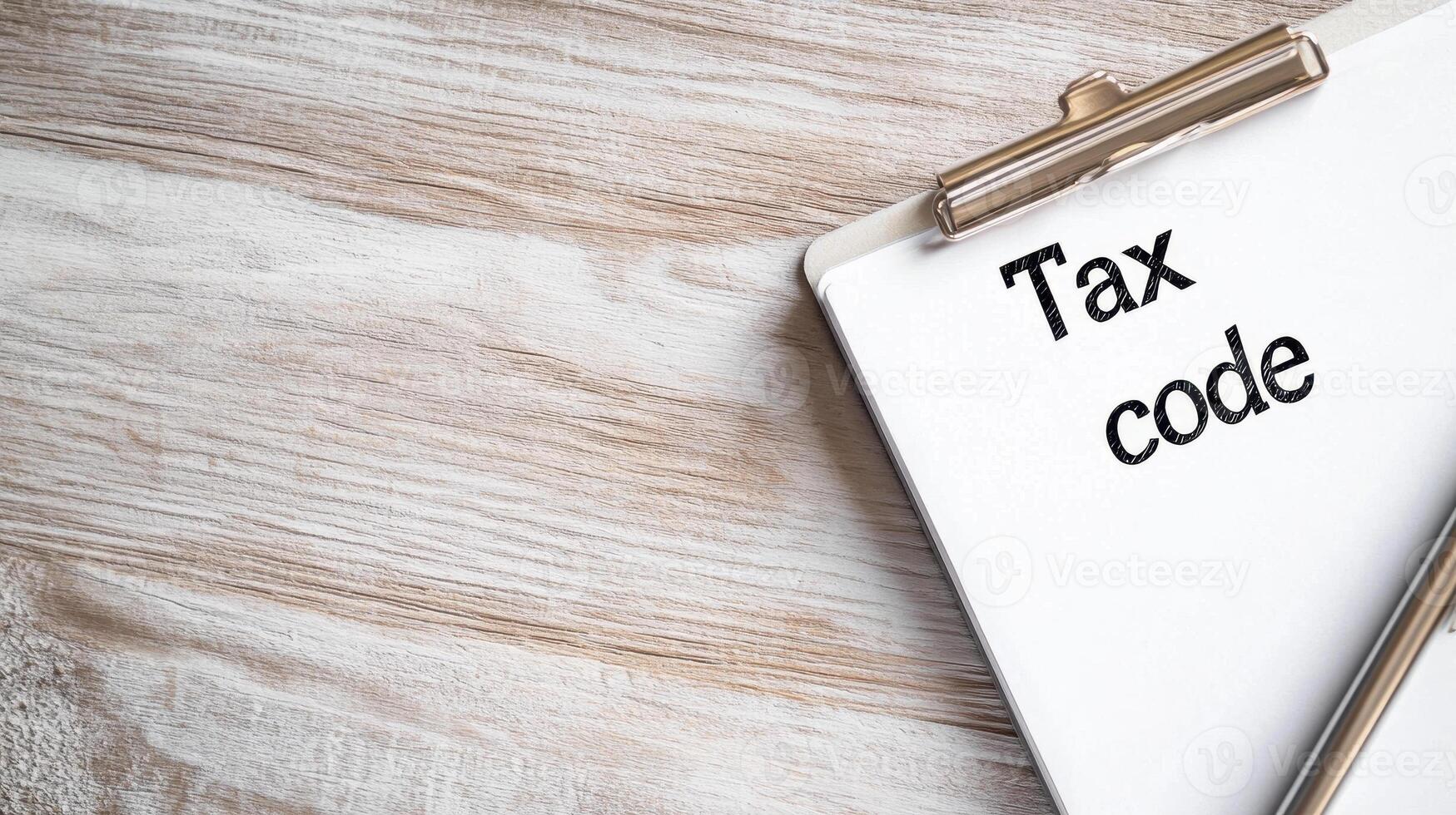 Tax code document on clipboard resting on wooden surface, symbolizing financial planning and organization photo