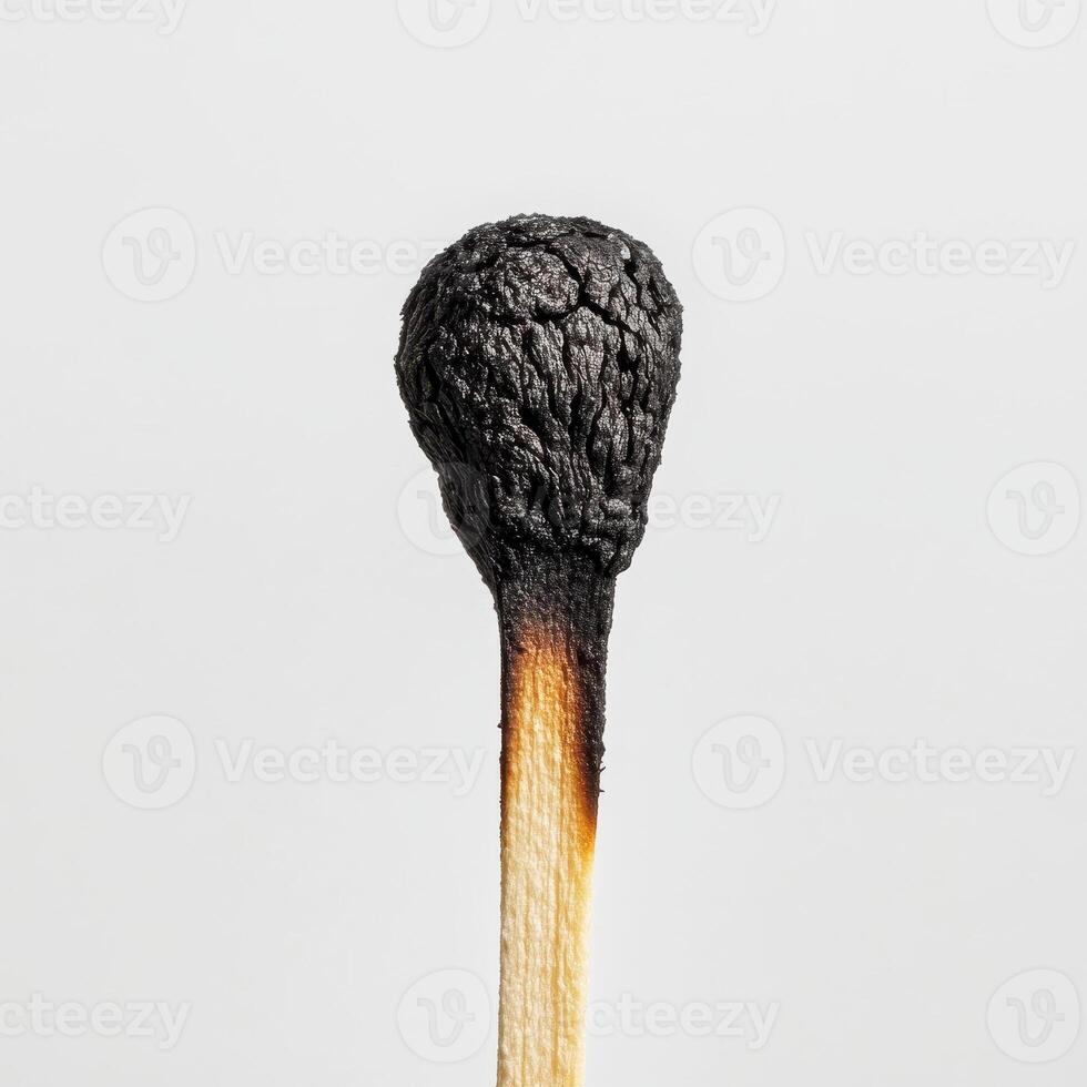 close up of burnt matchstick head, showcasing intricate textures and details. charred surface contrasts with wooden stick photo