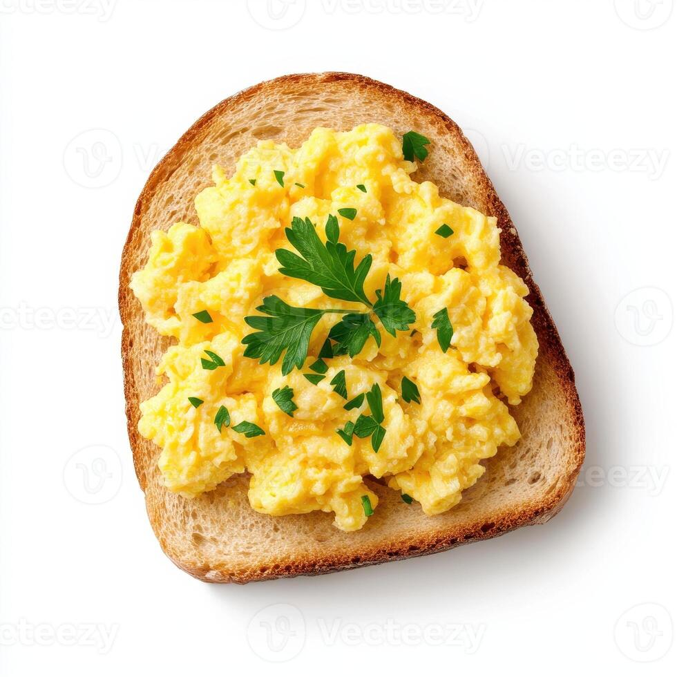 Scrambled eggs on toasted bread garnished with fresh parsley photo