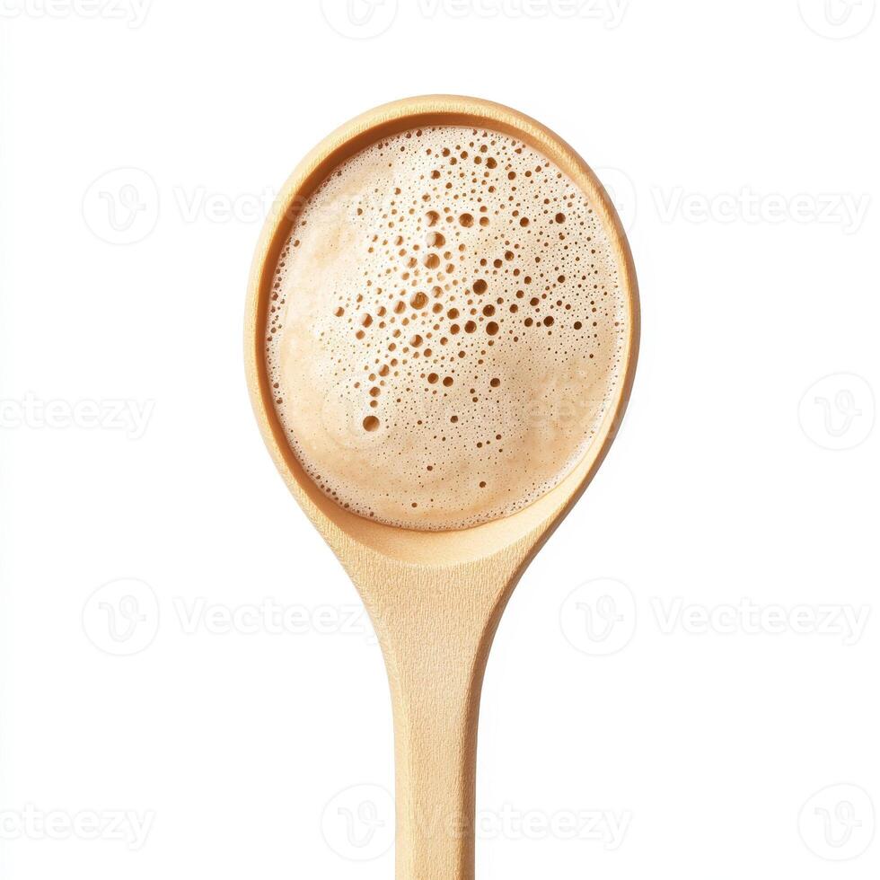 Top view of pancake batter in wooden spoon, ready for cooking. smooth texture and bubbles indicate freshness and quality photo