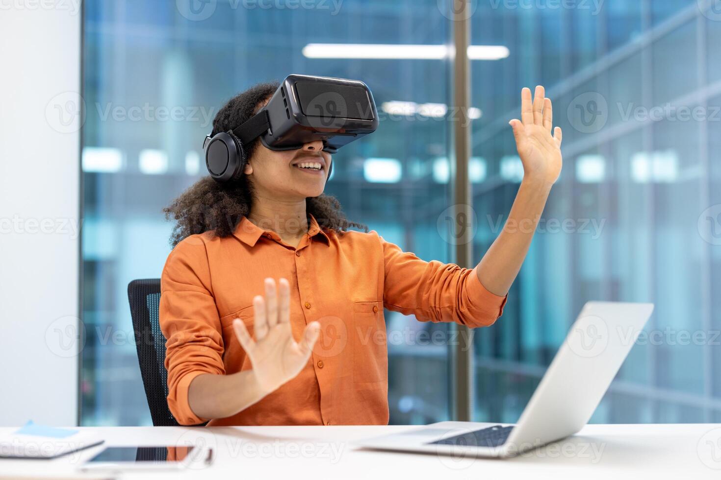 Woman using VR headset at desk, immersed in virtual environment. Professional setting highlights technology's role in innovation, creativity, and productivity in office work. photo