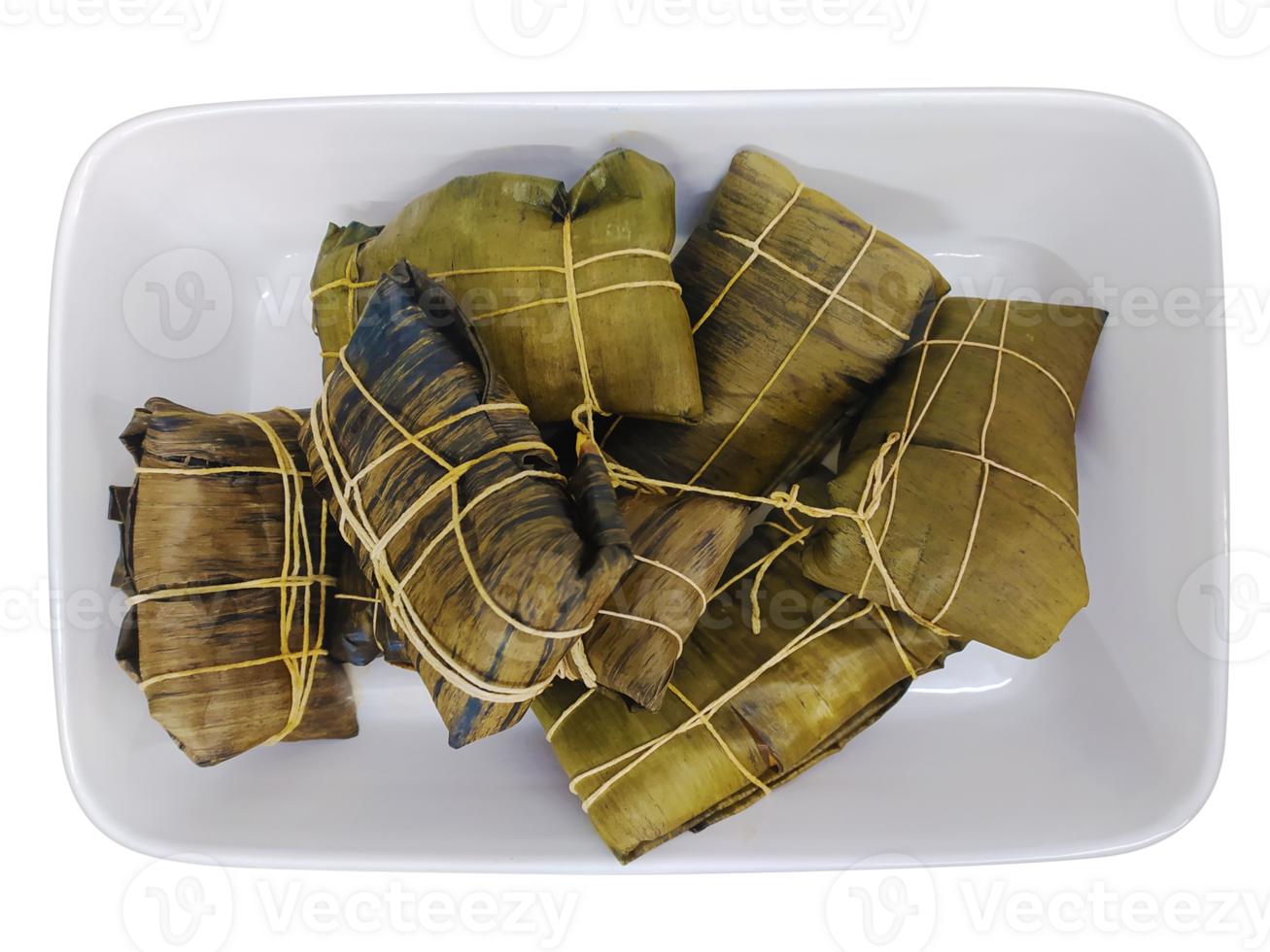 Delicious tamales, meticulously wrapped in banana leaves and tied with twine, rest in a white rectangular dish. A vibrant overhead shot, perfect for food blogs, culinary websites, and recipe books. png