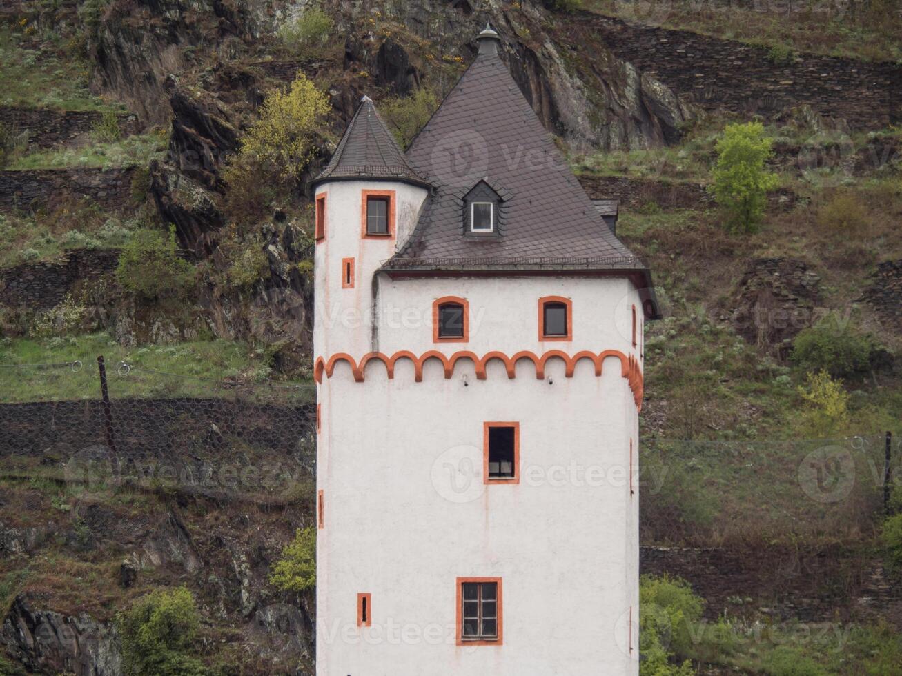 A white tower with a red trim at the rhine river photo