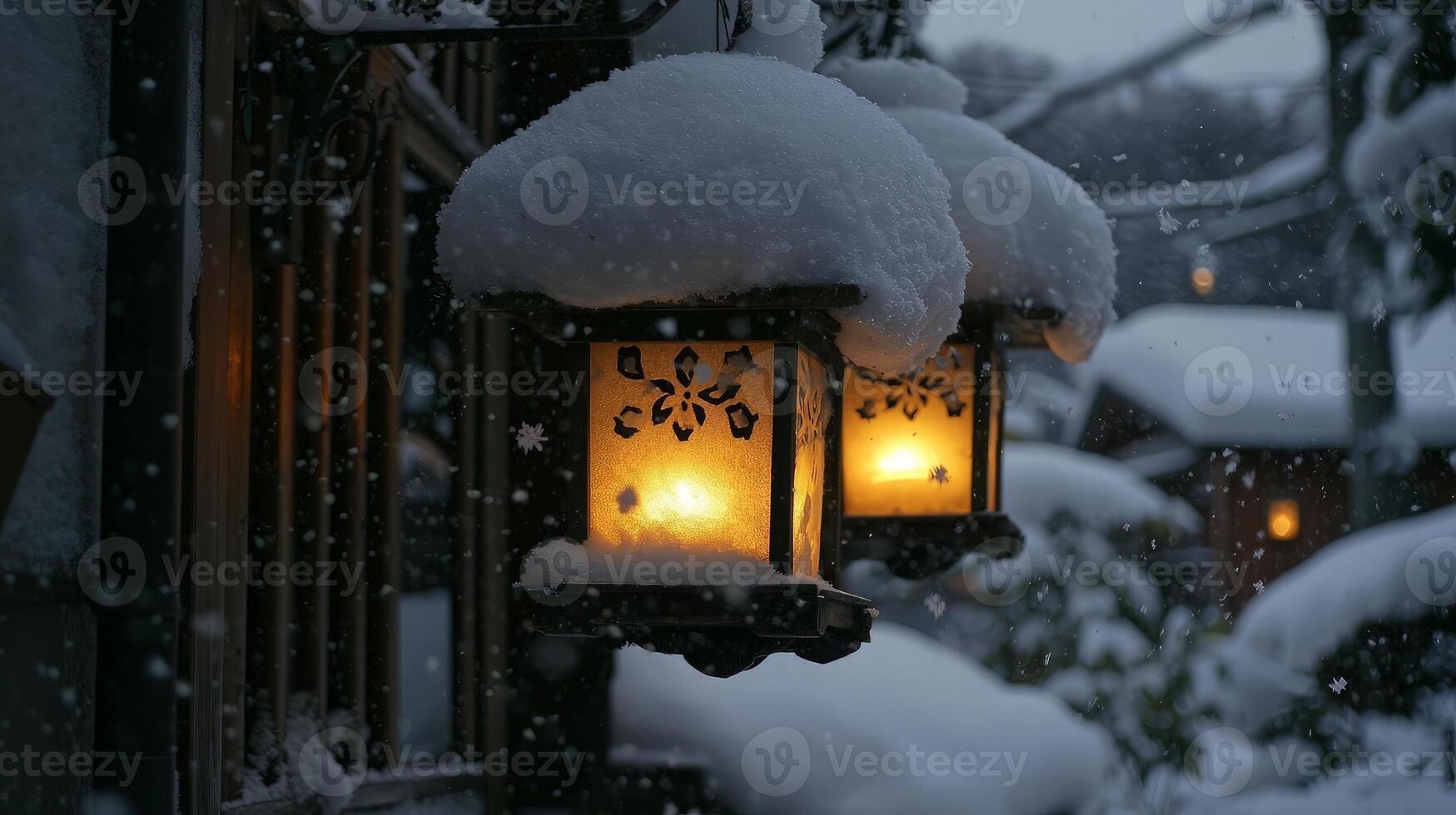 Snow-covered lanterns glow warmly in a winter scene. photo