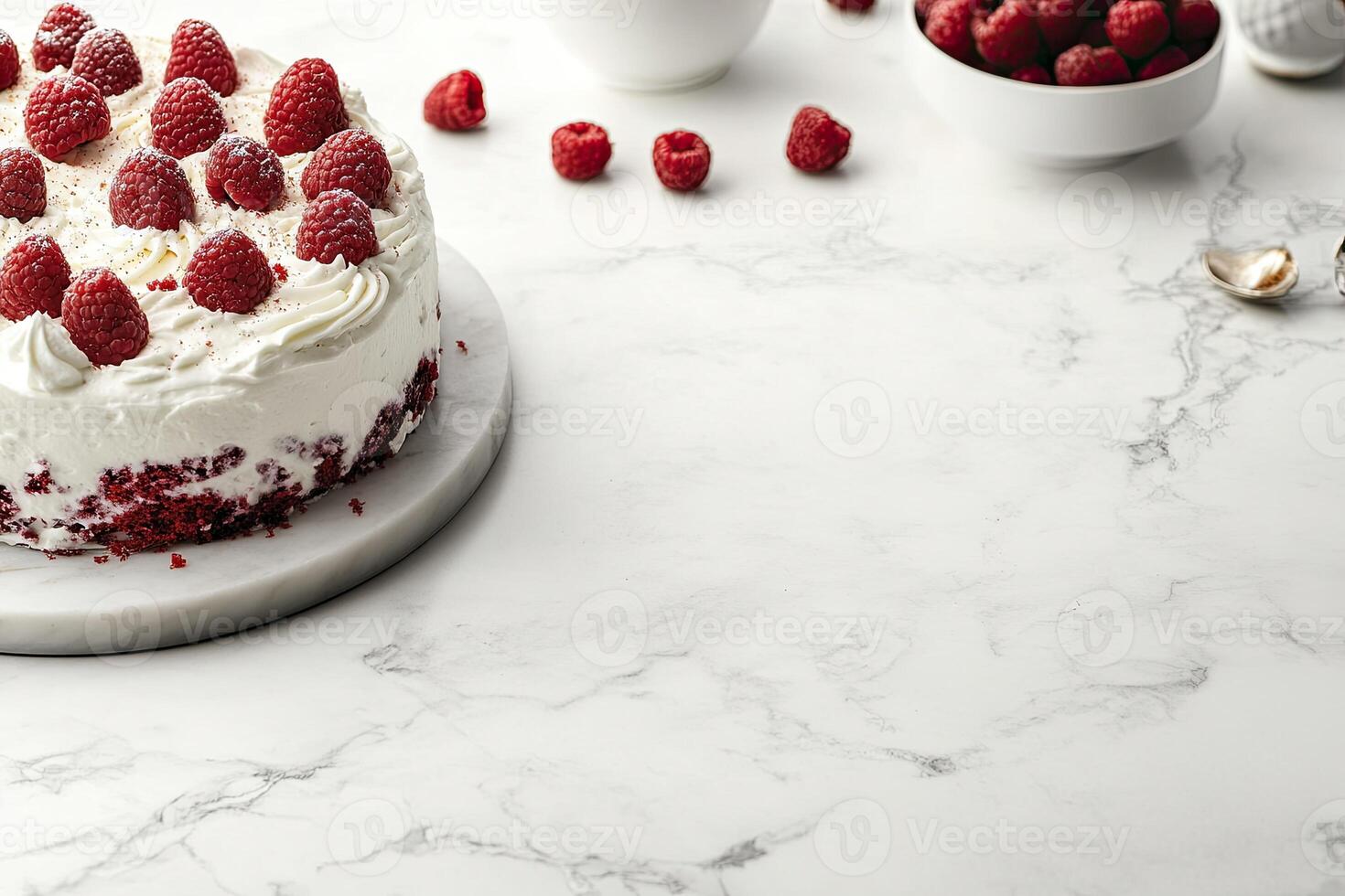 A cake with white frosting and raspberries on top photo