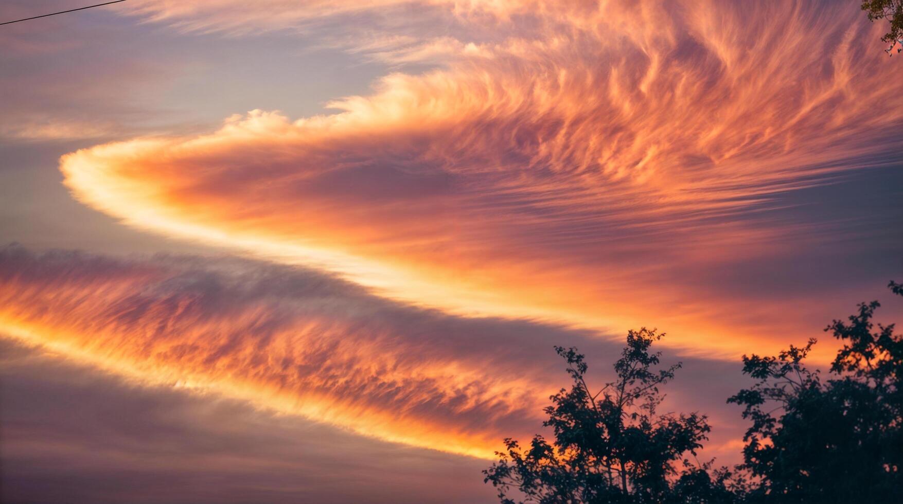 A vivid sunset with thin stretches of bright clouds and diffused by a soft glow. photo