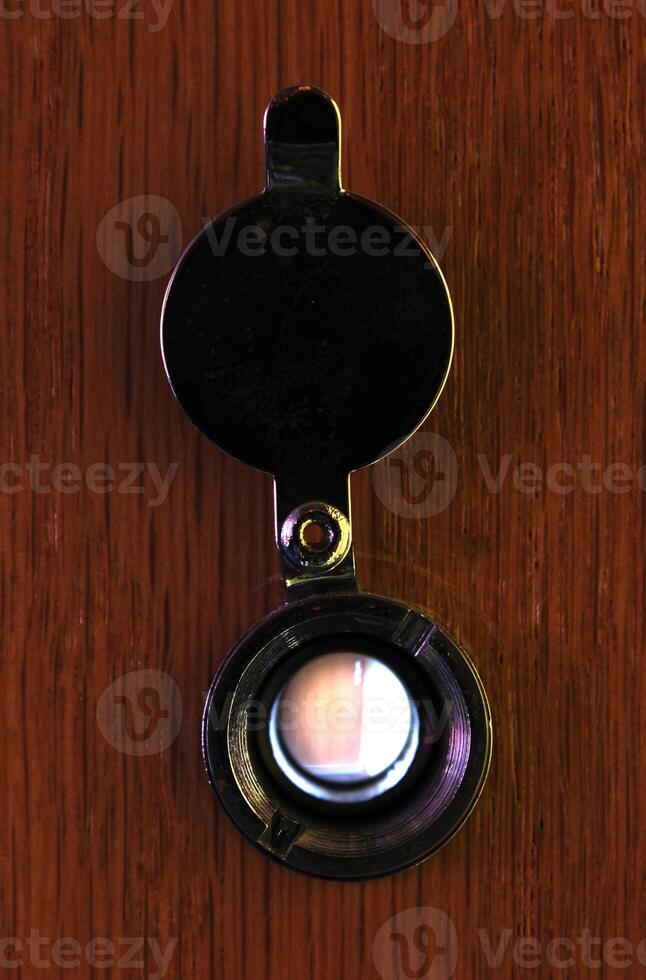 Looking through a door viewer at another door. photo