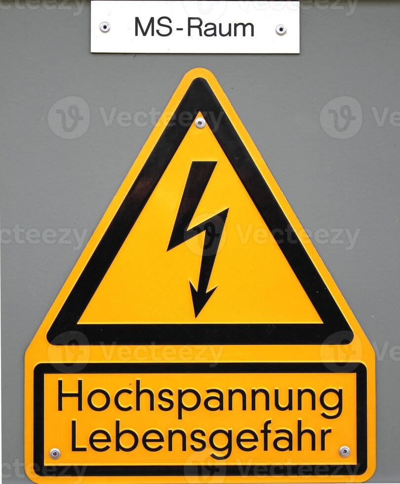 High voltage sign in Germany. The top line means Mittelspannungs-Raum medium voltage area, the lower lines mean high voltage life danger. photo