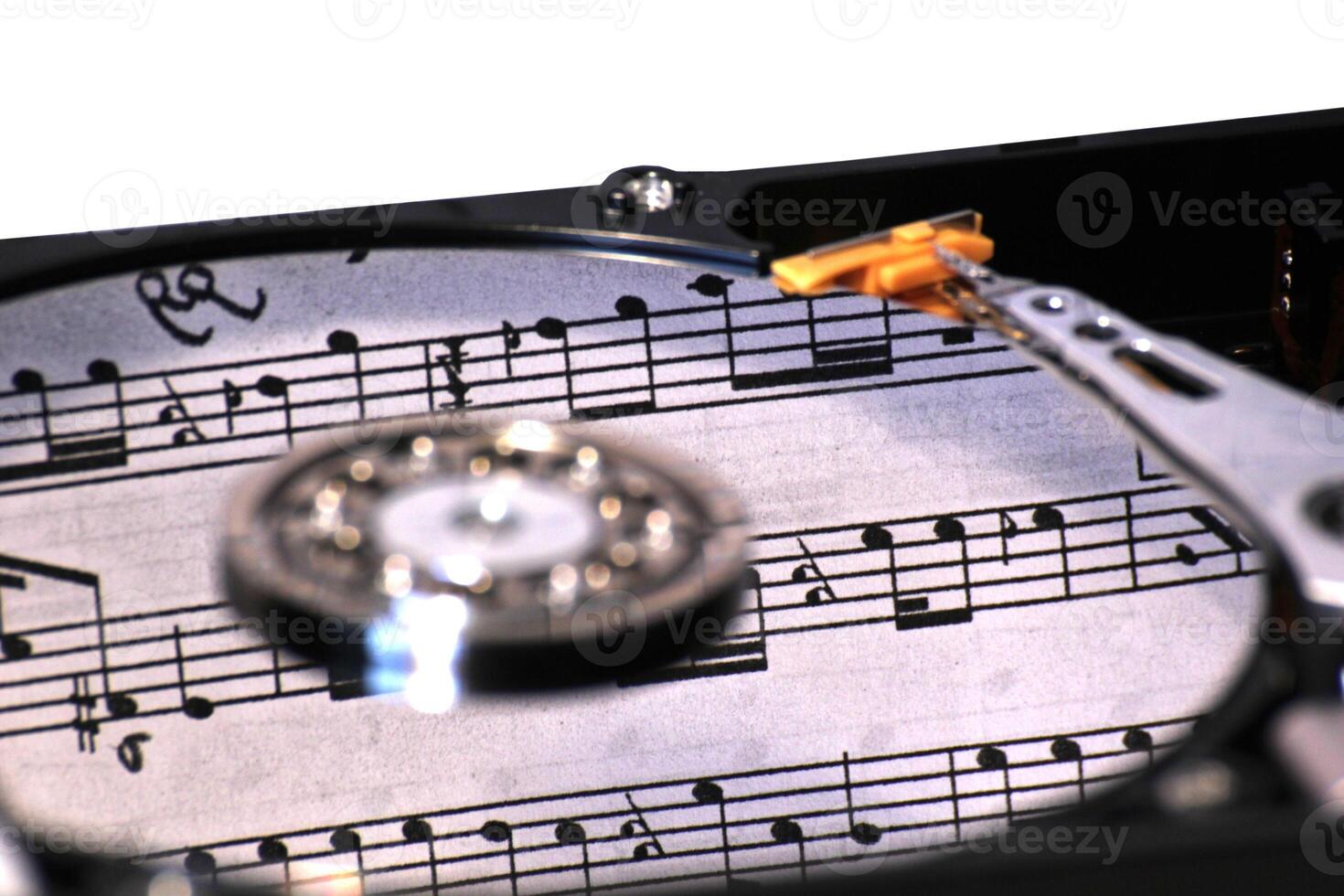 Hard disk on a white background with reflection of music notes. photo