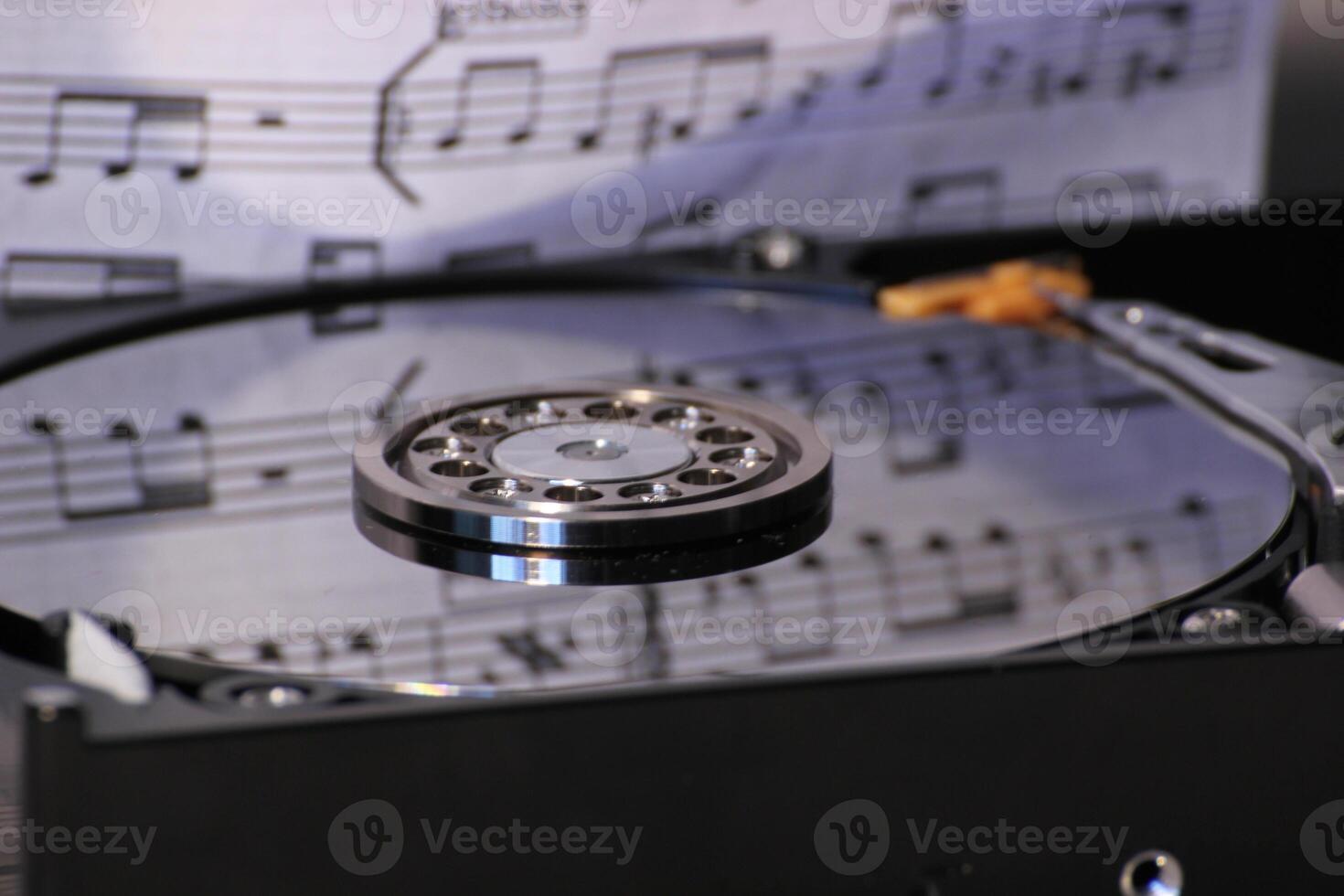 Hard disk with reflection of music notes. photo