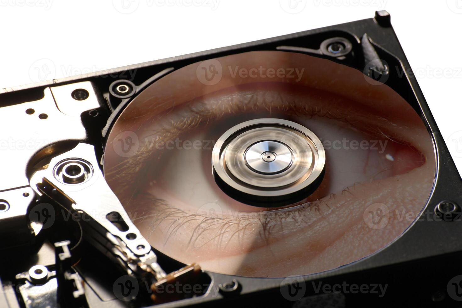 Hard disk on a black background, reflecting eye closeup. photo