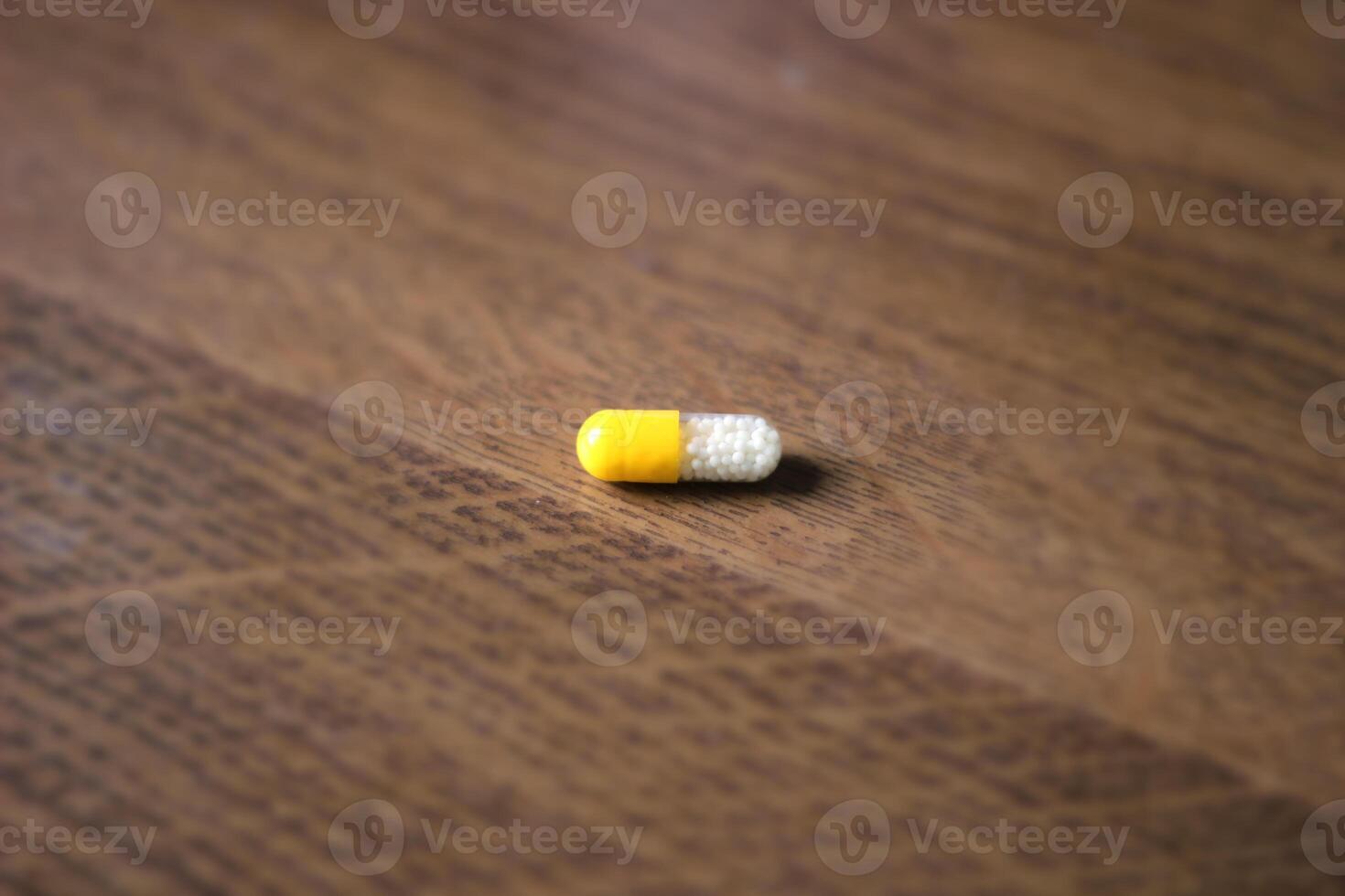 Pill on a wooden background. photo