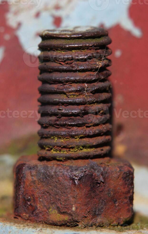 Close up of a rusty screw with nut. photo