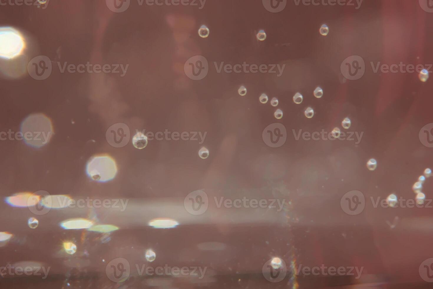 Bubbles and glare on brown background. photo