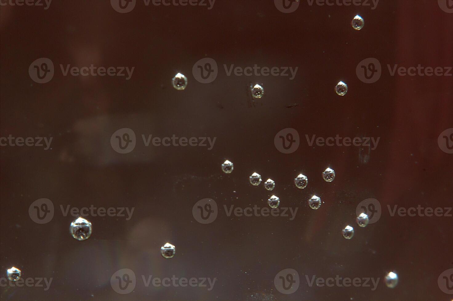 Bubbles and glare on brown background photo