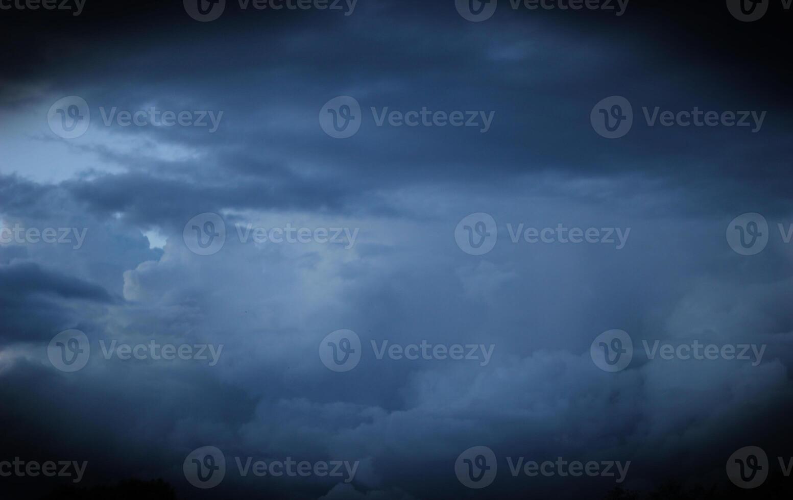 Heavy and dark clouds in the evening with vignetting. photo