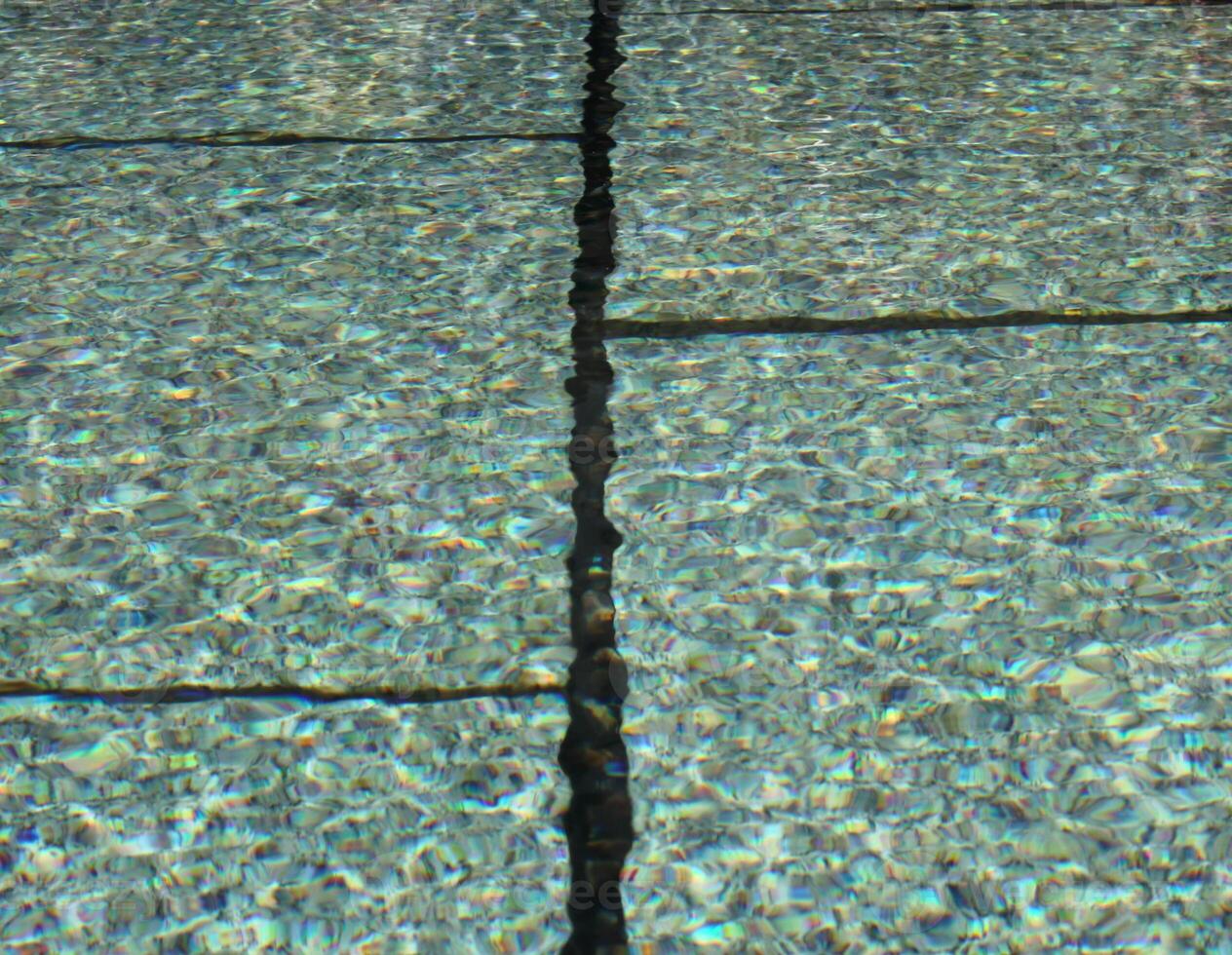 View of a fountain basin with soft waves and reflections usable as background. photo
