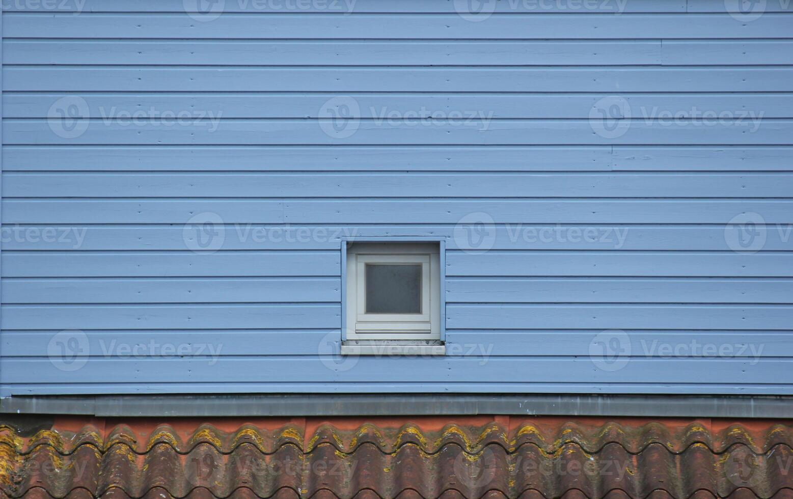 Window in blue wooden wall. photo