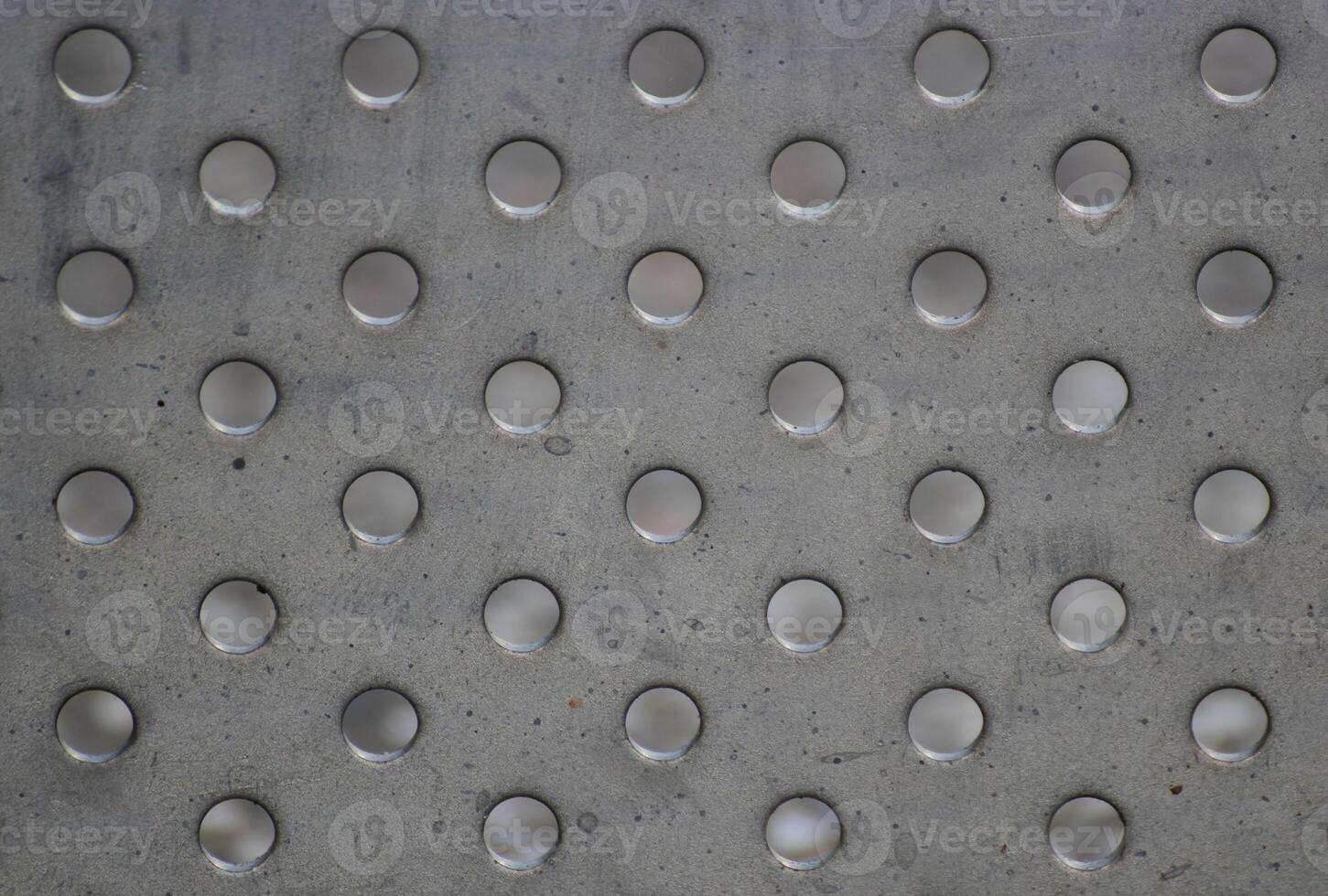 Background of metal panel with many holes. photo