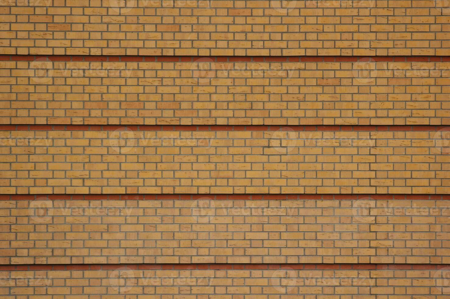 Yellow brick texture with red rows photo