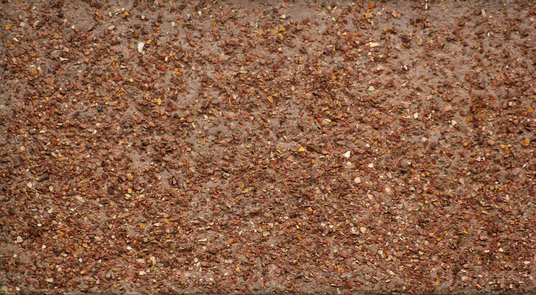 Red gravel texture from wall. photo