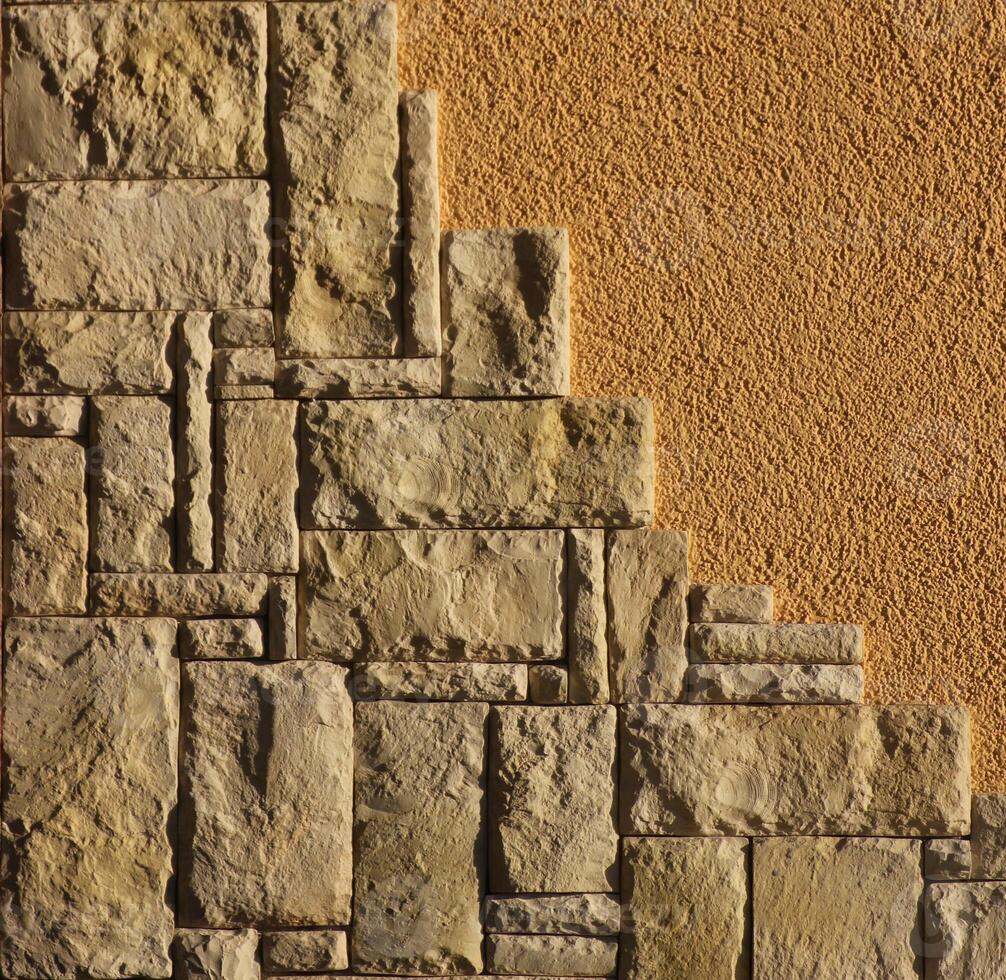 Freestone and standard plaster on a wall. photo