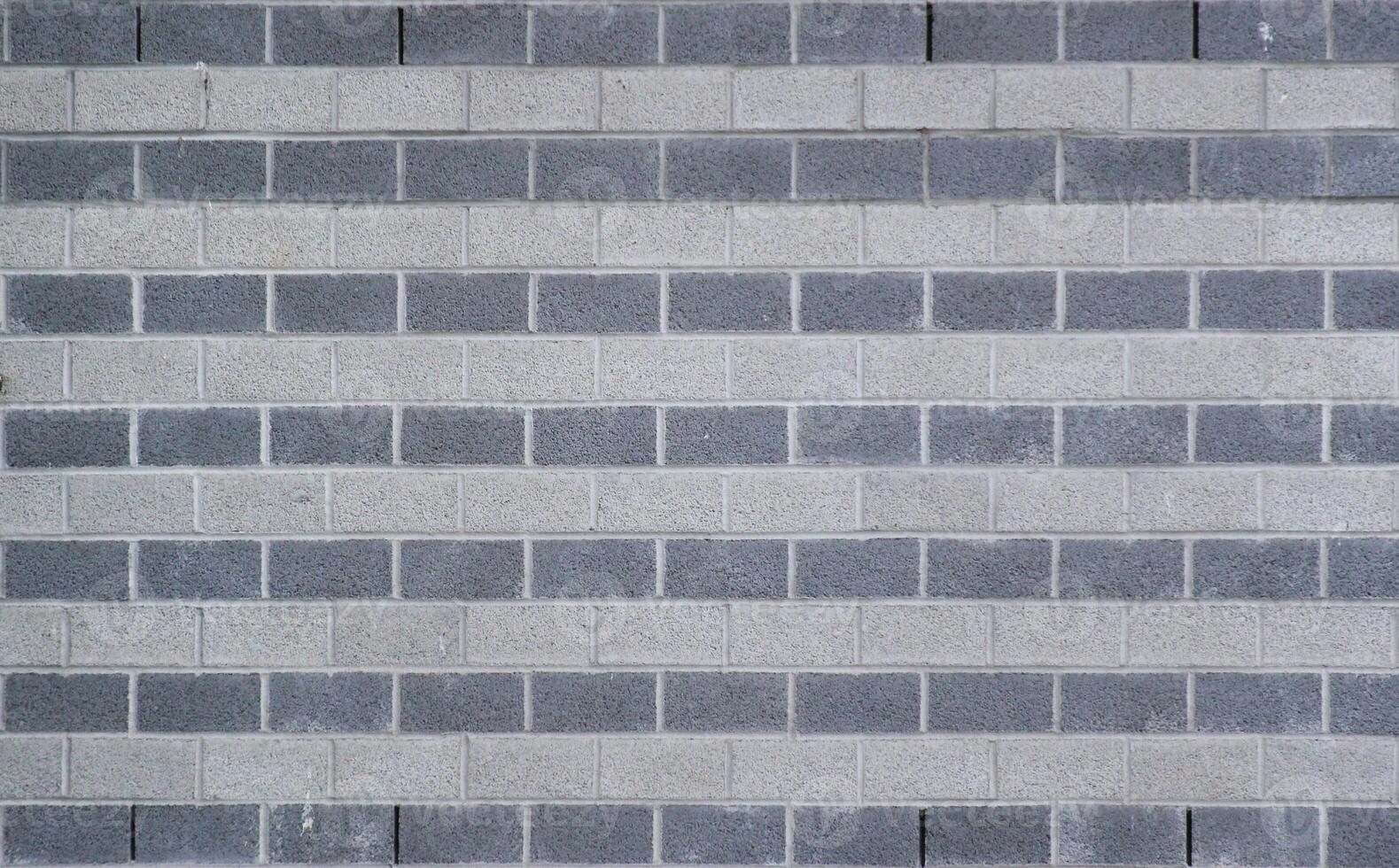 Wall made from rows of white and gray bricks usable as background or texture. photo