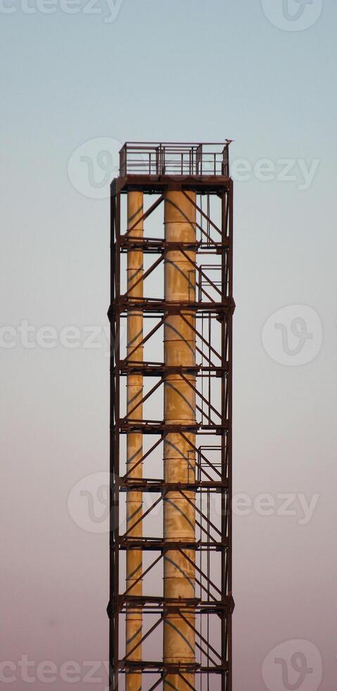 An industrial metal smoke pipe in sundawn photo